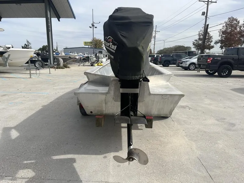 Slide: The Image of 2020 Custom 20 Crawfish Skiff with covered outboard motor in parking lot. - 11