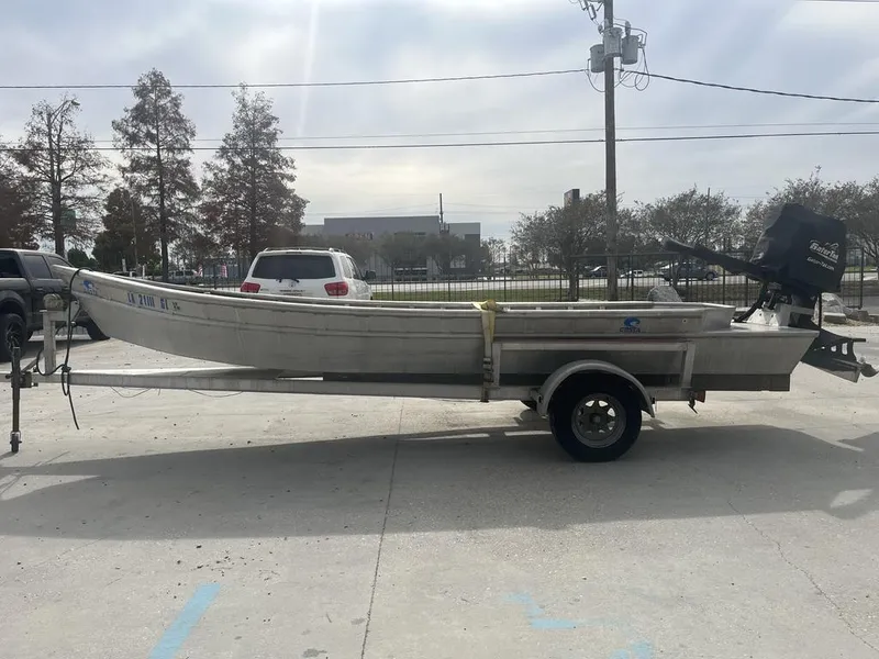 Slide: The Image of 2020 Custom 20 Crawfish Skiff on trailer in parking lot. - 2