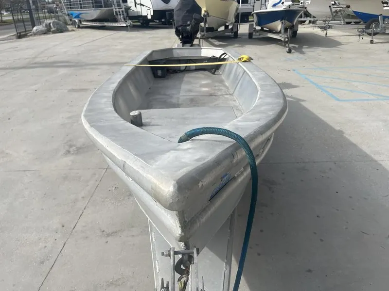 Slide: The Image of Custom 2020 Crawfish Skiff boat on trailer in a marina parking lot. - 3