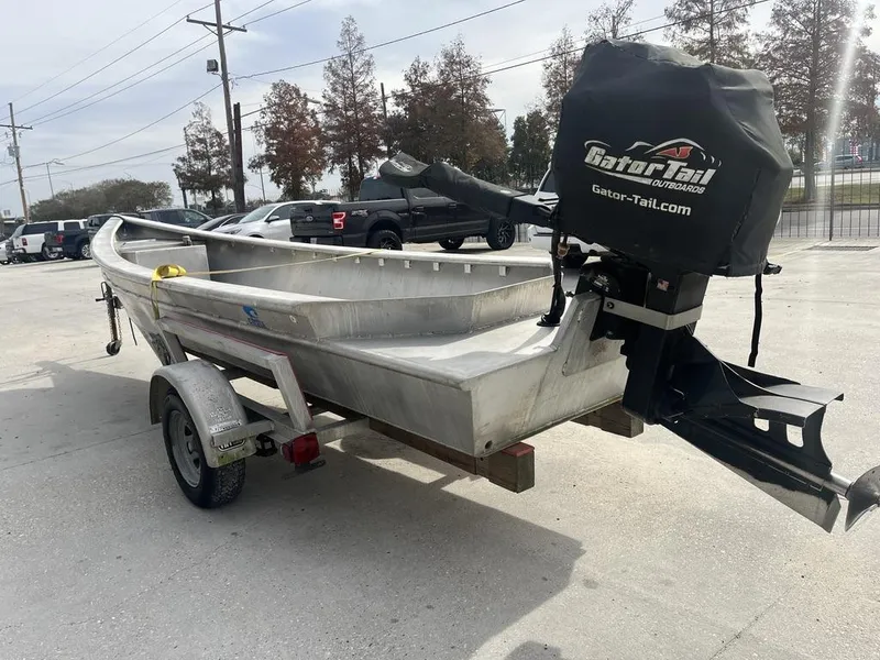 Slide: The Image of 2020 Custom 20 Crawfish Skiff on trailer with Gator Tail outboard motor. - 5