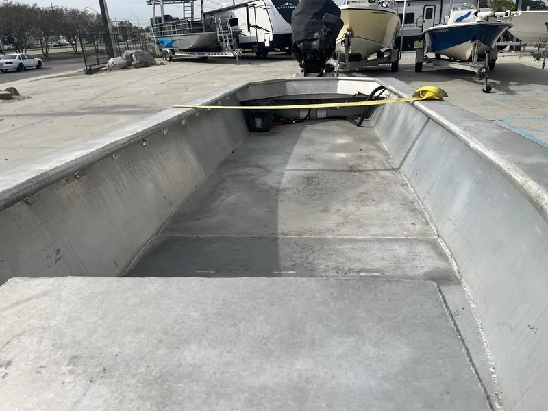 Slide: The Image of 2020 Custom 20 Crawfish Skiff boat interior, aluminum deck, parked in a marina. - 8