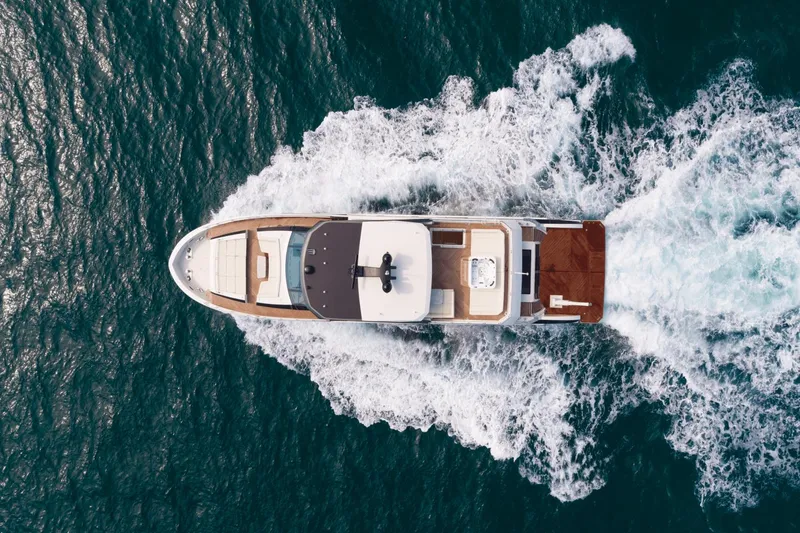 Slide: The Image of Aerial view of 2023 Ocean Alexander 32E yacht cruising on the ocean. - 11