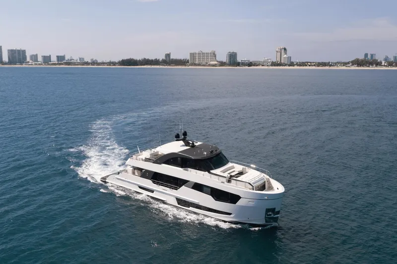 Slide: The Image of Ocean Alexander 32E 2023 yacht cruising near a coastal city. - 3