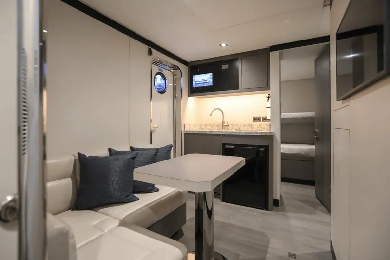 Slide: The Image of Modern interior of 2023 Ocean Alexander 32E yacht with kitchenette, seating area, and bunk beds. - 49