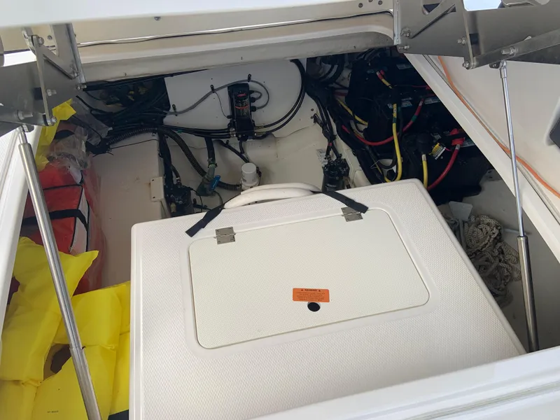 Slide: The Image of Engine compartment of a 2020 Chaparral 280 OSX boat with visible wiring and storage. - 27