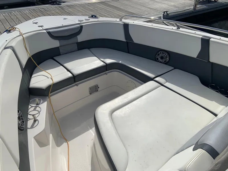 Slide: The Image of 2020 Chaparral 280 OSX boat interior with cushioned seating and dock in background. - 29