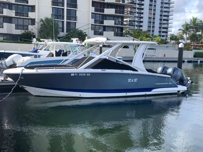 Slide: The Image of 2020 Chaparral 280 OSX boat docked in marina with modern buildings in background. - 3