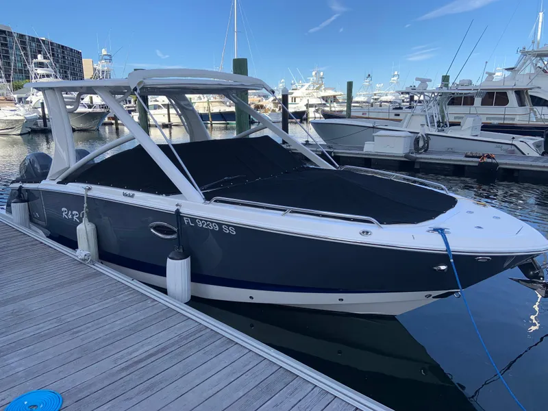 Slide: The Image of 2020 Chaparral 280 OSX boat docked at a marina. - 8