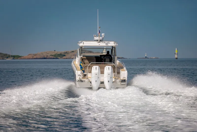 Slide: The Image of Nimbus W11 2025 motorboat cruising on open water, leaving a wake behind. - 2