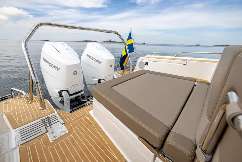 Slide: The Image of Luxury Nimbus W11 2025 boat with twin Mercury engines and Swedish flag on open water. - 8