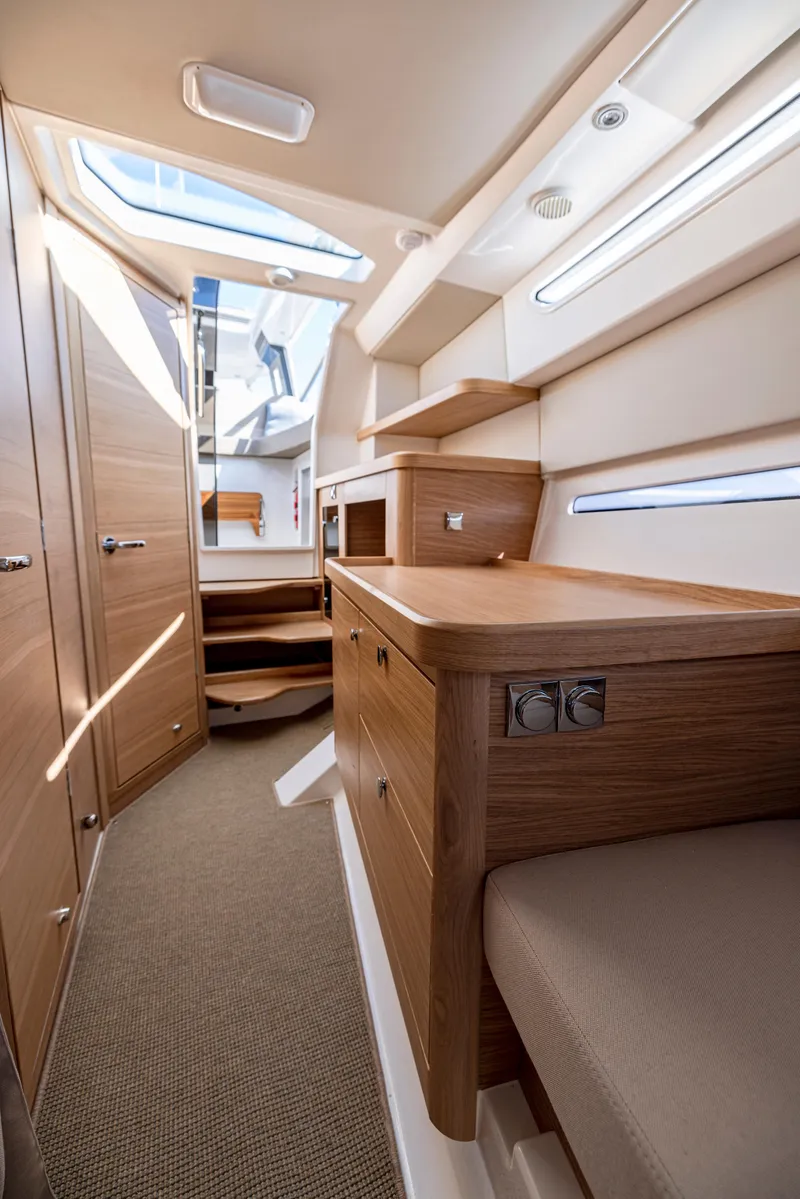 Slide: The Image of Interior of 2025 Nimbus W11 yacht, featuring modern wood cabinetry and sleek design. - 9