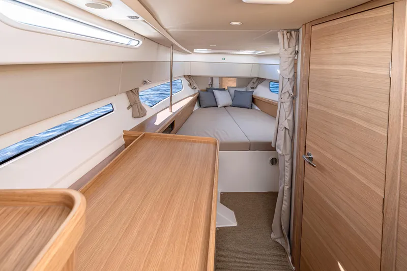 Slide: The Image of Luxurious interior of 2025 Nimbus W11 yacht with cozy bed and wooden finishes. - 11