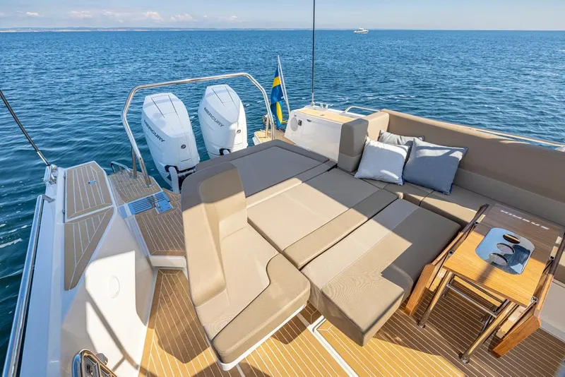 Slide: The Image of Luxurious 2025 Nimbus W11 yacht deck with sun loungers and ocean view. - 7
