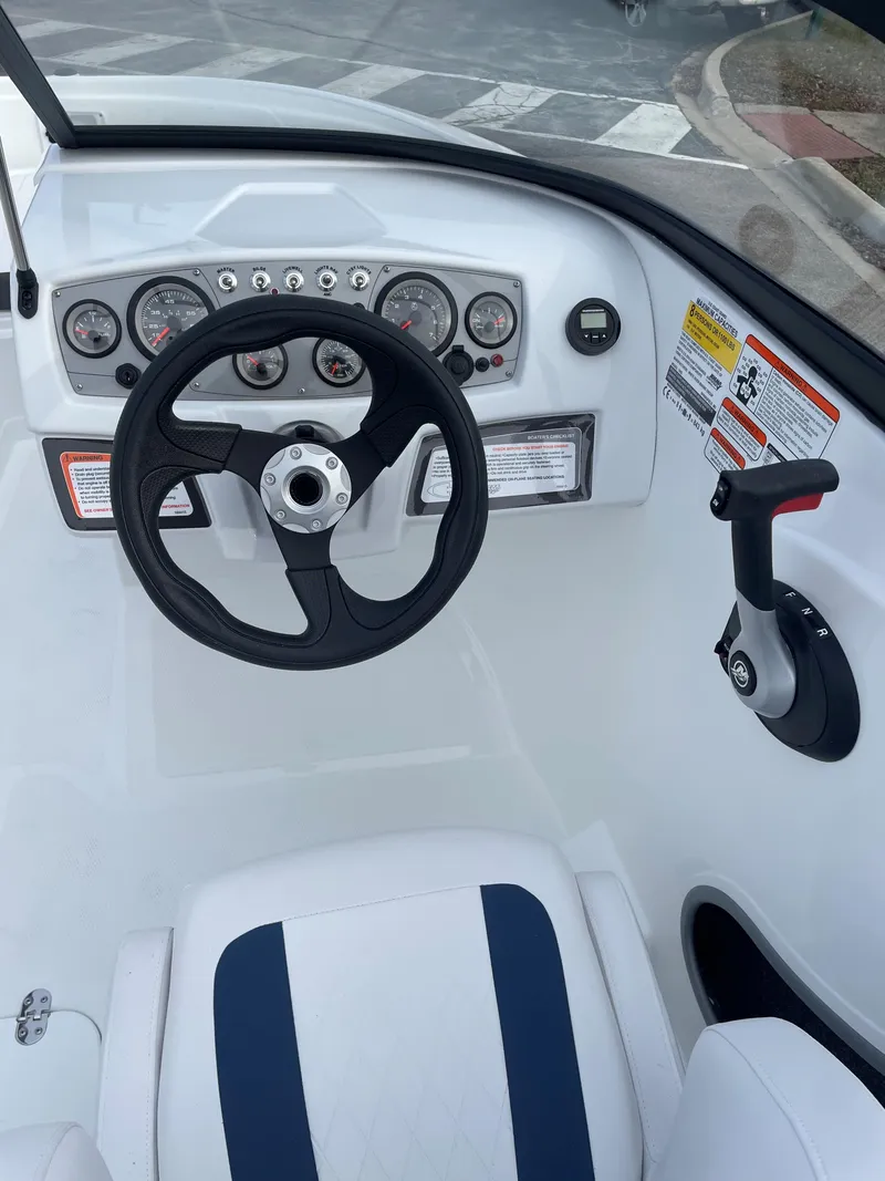 Slide: The Image of Steering console of a 2024 Tahoe 185 S boat with gauges and controls. - 2