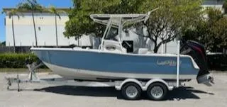The Image of 2024 Mako 214 CC boat on a trailer, parked outdoors. - 0