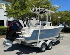 Slide: The Image of 2024 Mako 214 CC boat on a trailer with an outboard motor. - 3