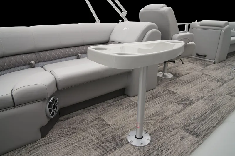 Slide: The Image of 2024 Ranger Reata 243C boat interior with gray seating and a central table. - 34