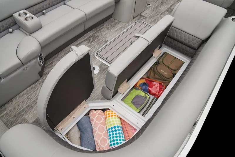 Slide: The Image of 2024 Ranger Reata 243C boat with open storage compartment and organized gear. - 35
