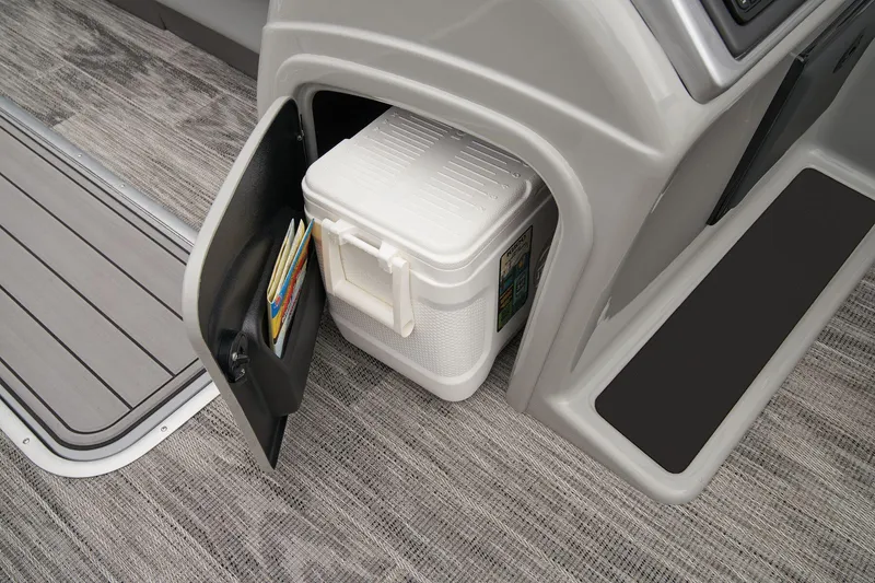 Slide: The Image of 2024 Ranger Reata 243C storage compartment with cooler and magazines. - 39