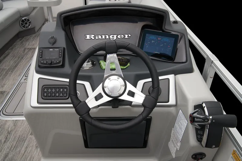Slide: The Image of 2024 Ranger Reata 243C boat dashboard with steering wheel and control panel. - 43