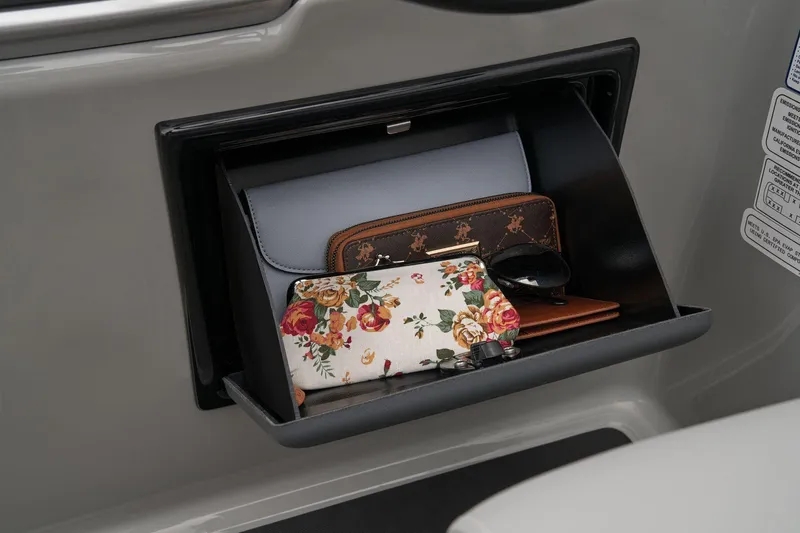 Slide: The Image of Storage compartment in 2024 Ranger Reata 243C with wallets and accessories. - 51