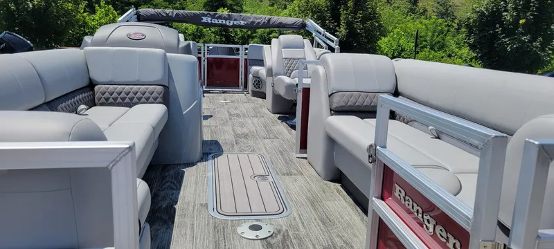 Slide: The Image of 2024 Ranger Reata 243C pontoon boat with spacious seating and modern design. - 7