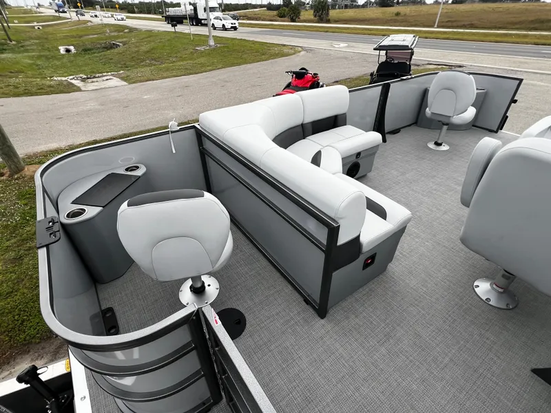 Slide: The Image of 2024 Bentley Pontoons LE 180 3 PT interior with modern seating and spacious layout. - 12