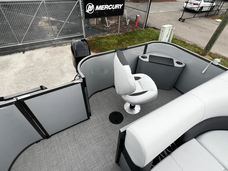 Slide: The Image of 2024 Bentley Pontoons LE 180 3 PT interior with captain's chair and Mercury engine. - 13