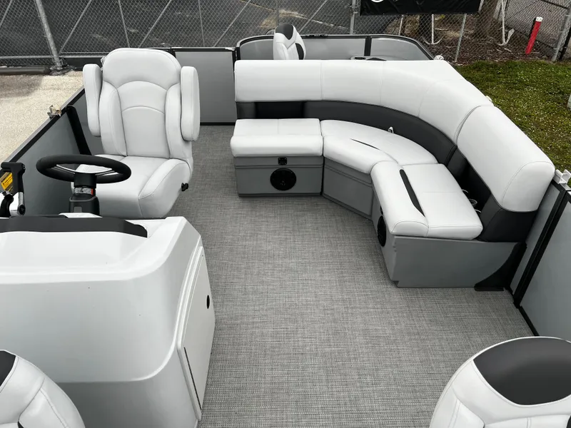 Slide: The Image of 2024 Bentley Pontoons LE 180 3 PT interior with plush seating and modern design. - 15