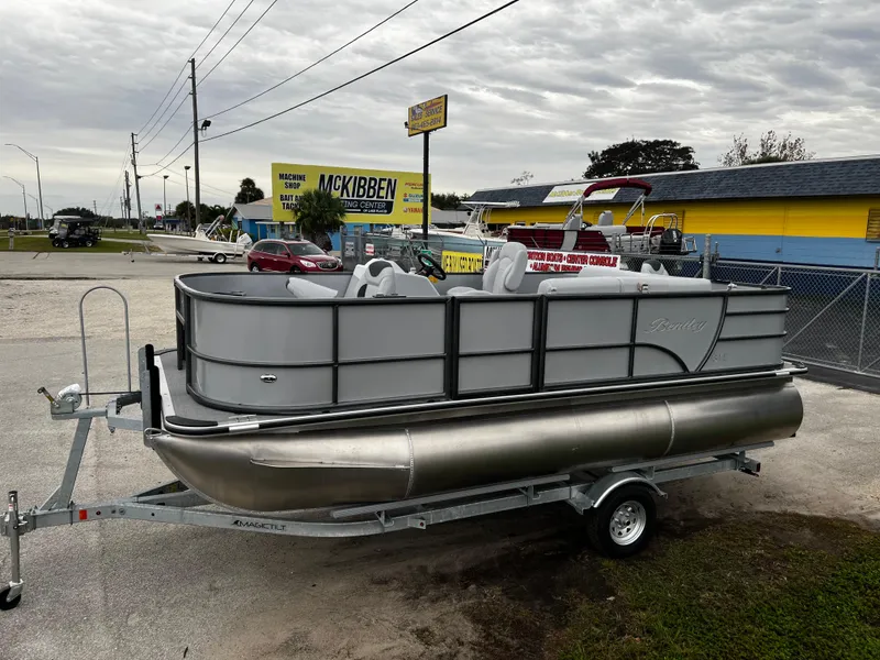 Slide: The Image of 2024 Bentley Pontoons LE 180 3 PT pontoon boat on trailer in dealership lot. - 4