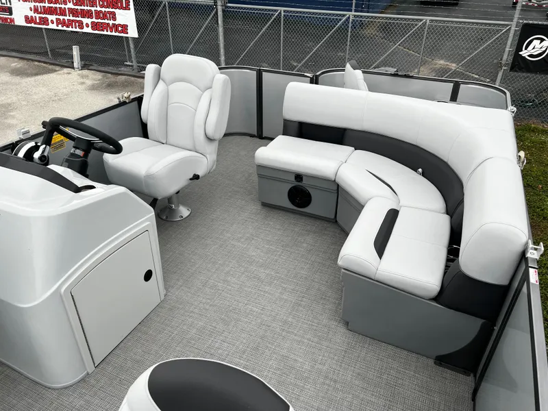Slide: The Image of 2024 Bentley Pontoons LE 180 3 PT interior with plush seating and modern design. - 8