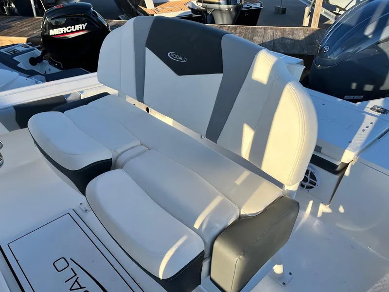 Slide: The Image of 2024 Robalo 246 Cayman boat seating with Mercury engine in background. - 12