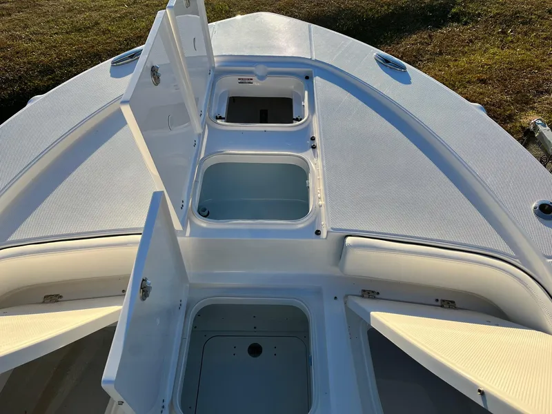 Slide: The Image of 2024 Robalo 246 Cayman boat with open storage compartments. - 19