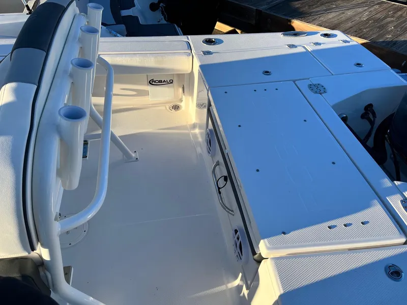 Slide: The Image of 2024 Robalo 246 Cayman boat deck with rod holders and storage compartments. - 9