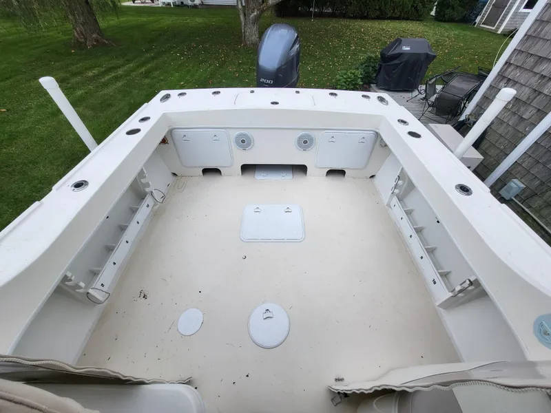 Slide: The Image of 2018 Steiger Craft 21 DV MIAMI boat deck with storage compartments and outboard motor. - 28