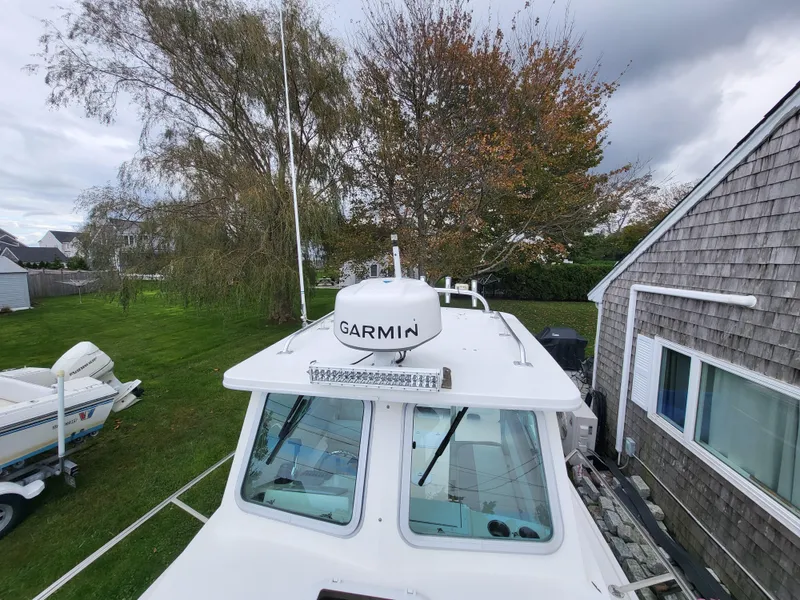 Slide: The Image of 2018 Steiger Craft 21 DV MIAMI boat with Garmin radar, docked near a house. - 32