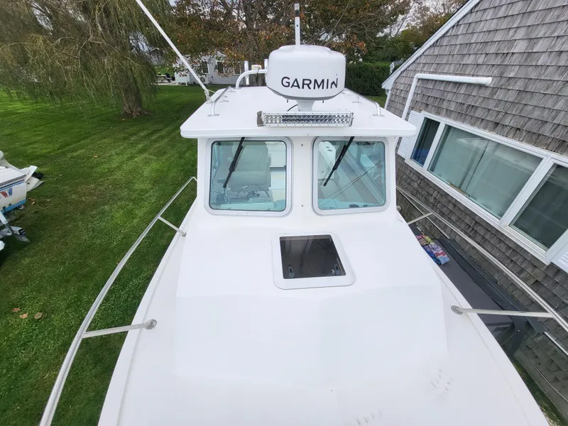 Slide: The Image of 2018 Steiger Craft 21 DV MIAMI boat with Garmin radar, docked near a house. - 37