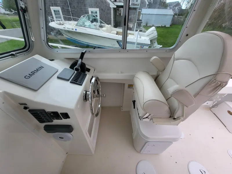 Slide: The Image of 2018 Steiger Craft 21 DV MIAMI boat interior with captain's chair and Garmin navigation system. - 44