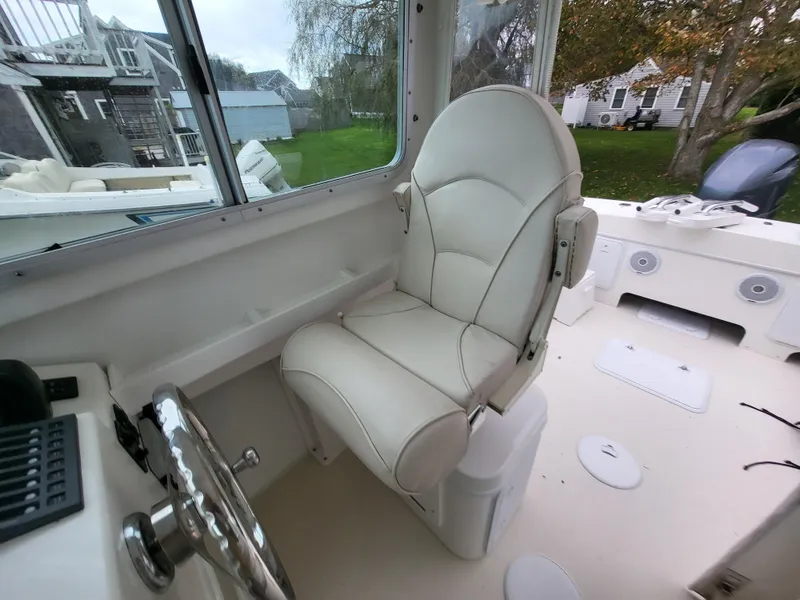 Slide: The Image of Captain's chair in 2018 Steiger Craft 21 DV MIAMI boat, featuring a sleek, white interior. - 45