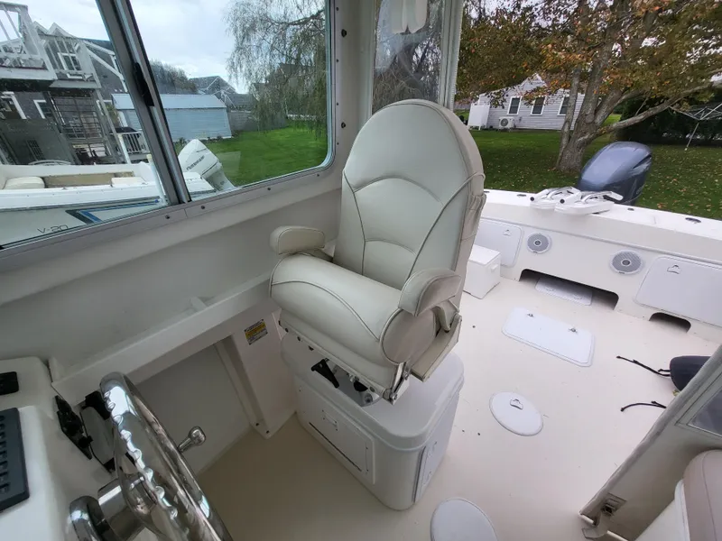 Slide: The Image of 2018 Steiger Craft 21 DV MIAMI boat interior with captain's chair and steering wheel. - 47