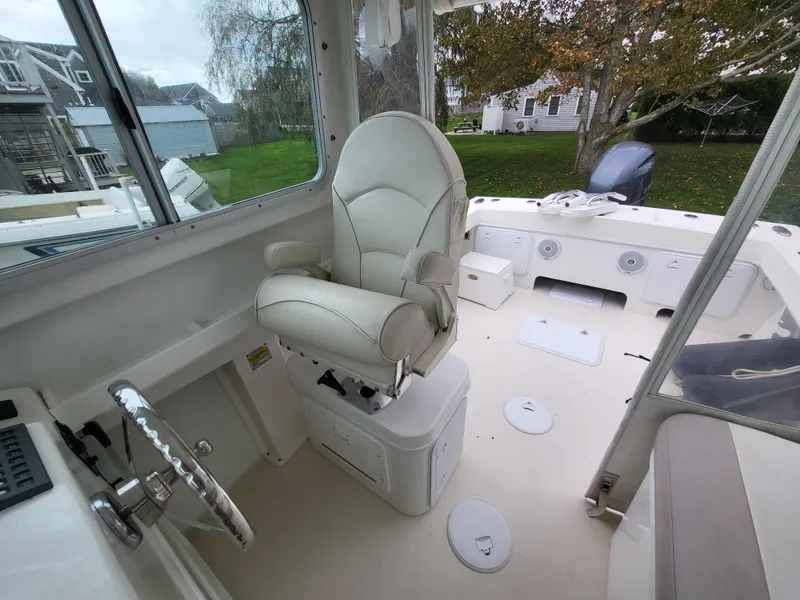Slide: The Image of 2018 Steiger Craft 21 DV MIAMI boat interior with captain's chair and steering wheel. - 49