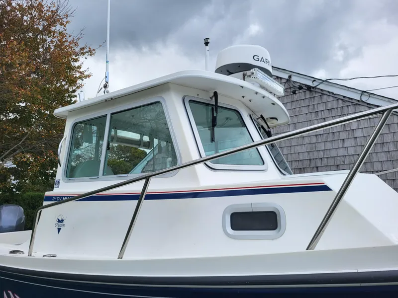 Slide: The Image of 2018 Steiger Craft 21 DV MIAMI boat with Garmin radar, docked near a wooden building. - 9