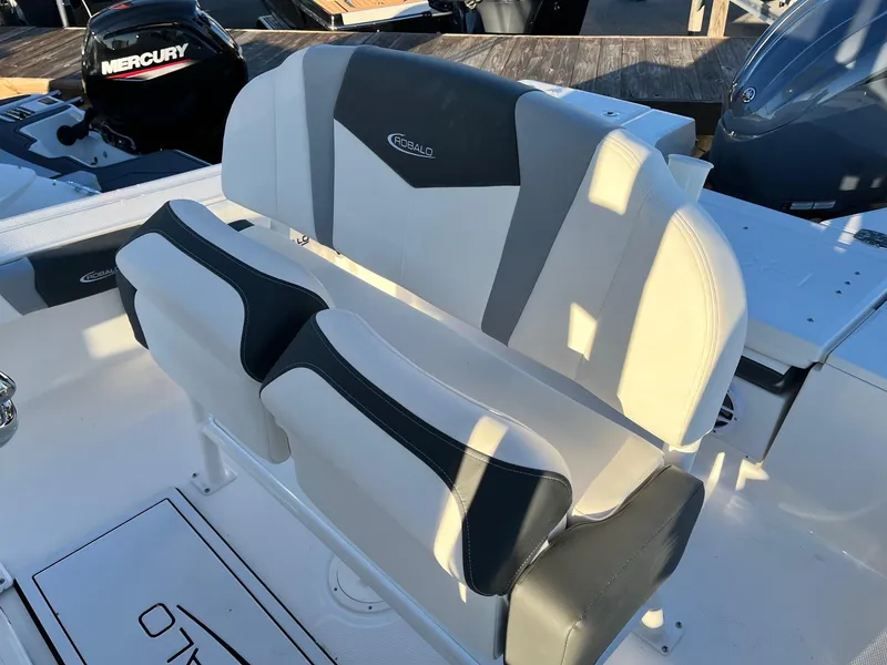 Slide: The Image of 2024 Robalo 246 Cayman boat seating with Mercury engine in background. - 11