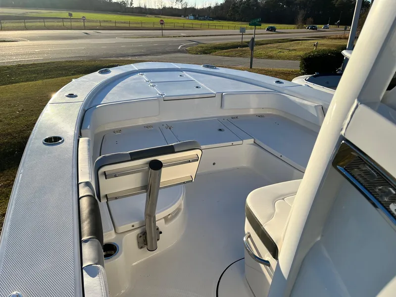 Slide: The Image of 2024 Robalo 246 Cayman boat interior, featuring spacious seating and storage compartments. - 13