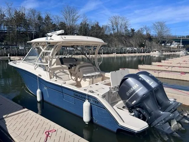 Slide: The Image of 2019 Grady-White Freedom 325 boat docked, featuring twin Yamaha outboard engines. - 15