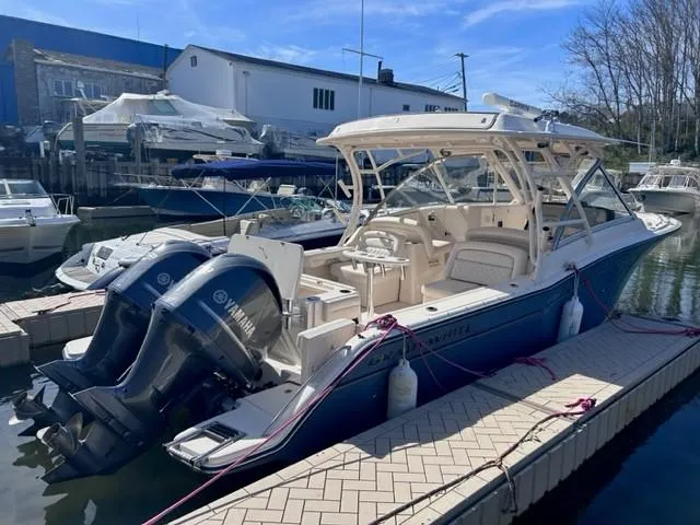 Slide: The Image of 2019 Grady-White Freedom 325 boat docked with twin Yamaha engines. - 16