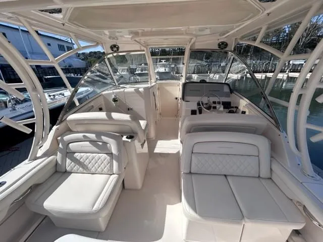 Slide: The Image of 2019 Grady-White Freedom 325 boat interior with luxurious seating and helm station. - 7