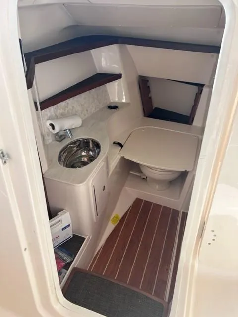 Slide: The Image of 2019 Grady-White Freedom 325 boat interior with sink and toilet. - 9