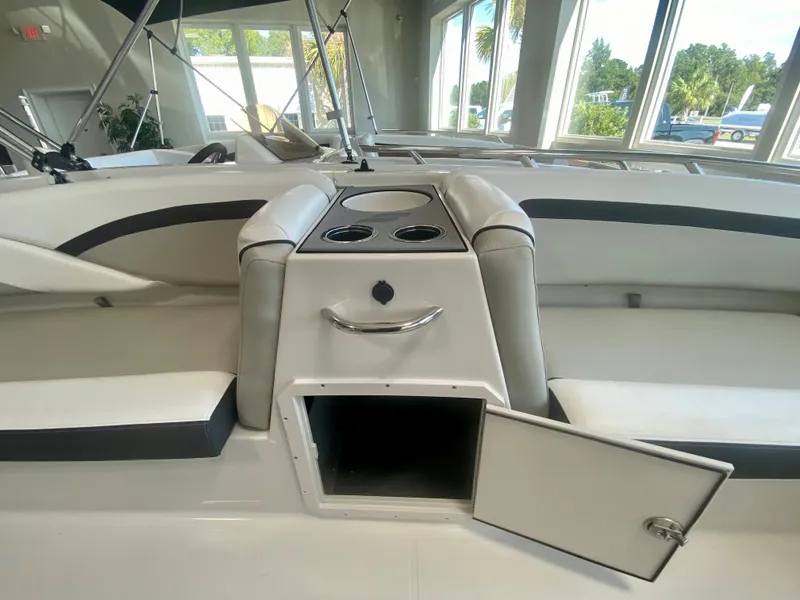 Slide: The Image of 2024 Starcraft SVX 191 boat interior with open storage compartment and cup holders. - 17
