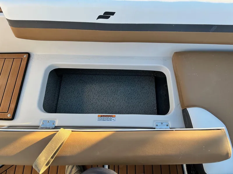 Slide: The Image of 2024 Starcraft SVX 191 boat storage compartment with cushioned seating. - 10